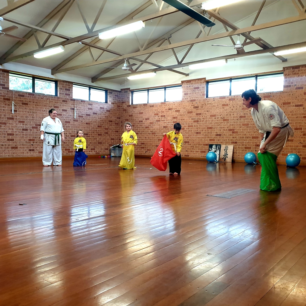 Senpai demonstrates the sack race to our younger Ninja students at Wollondilly Karate at Tahmoor